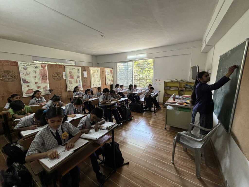 WonderKids Academy teacher teaching students at the board