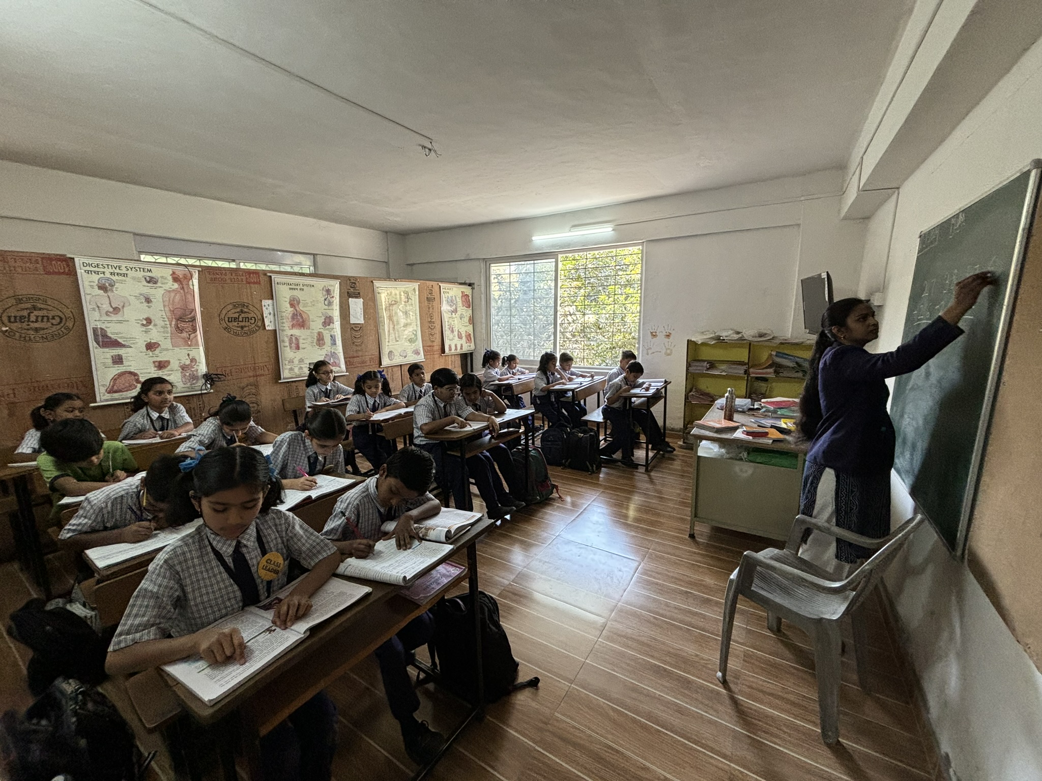 WonderKids Academy teacher teaching students at the board