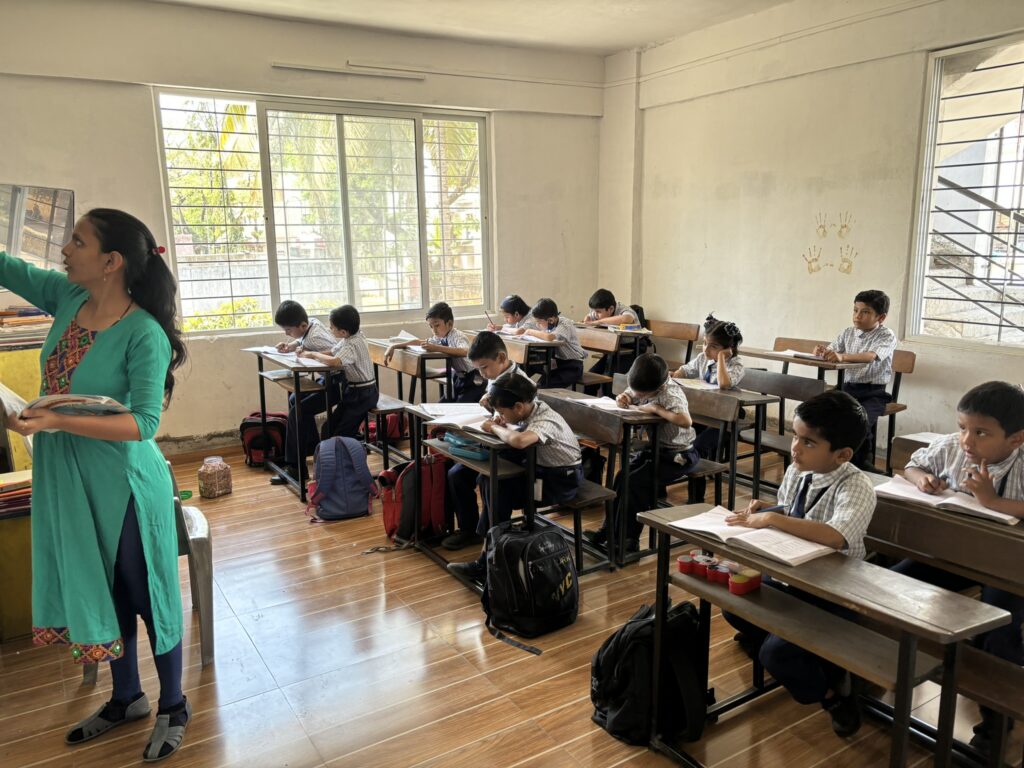 Teacher supporting students in the WonderKids Academy classroom